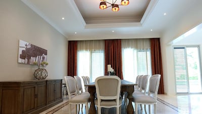 A dining area on the ground floor in a four-bedroom Mediterranean villa. The development is situated on 12,000 acres of land with 60 per cent given over to green space and an 8.8km cycle track around its perimeter. Satish Kumar / The National