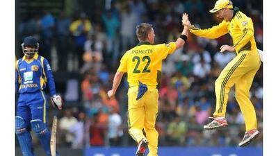 Xavier Doherty, centre, is congratulated by David Hussey, right, after taking the wicket of Chamara Silva during yesterday's one-day international in Colombo.