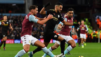 Manchester City's Riyad Mahrez, centre, weaves his way through the Aston Villa defence to score at Villa Park. AFP
