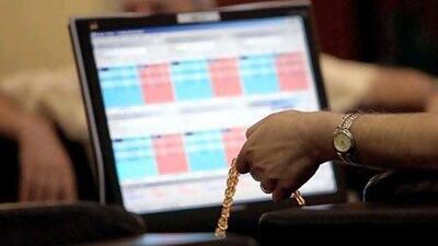 A trader follows the developments at the Dubai Financial Market. Ali Haider / EPA