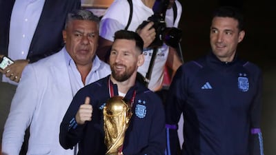 Lionel Messi with the World Cup trophy after arriving at Ezeiza International Airport on Tuesday, December 20, 2022. AFP