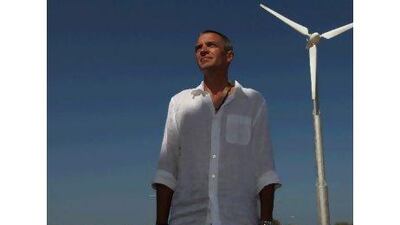 Michael Abel stands next to the wind turbine he installed for the energy efficient house of Ras al Khaimah's ruling family.