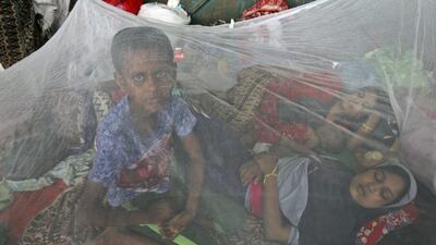 Ethnic Rohingya women and children sleep under a mosquito net at a temporary shelter in Langsa, Aceh province in Indonesia on May 17, 2015. Boats filled with more than 2,000 Bangladeshi and Rohingya migrants have landed in Indonesia, Malaysia and Thailand, and thousands more migrants are believed to be adrift at sea after a crackdown on human traffickers prompted smugglers to abandon their human cargo. Binsar Bakkara/AP Photo