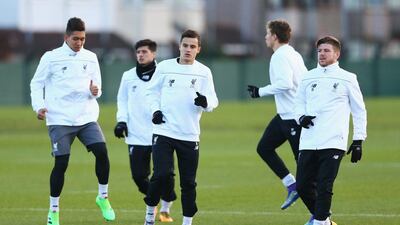 LIVERPOOL, ENGLAND - FEBRUARY 24: Philippe Coutinho (10) and Alberto Moreno (18) warm up with team mates during a Liverpool training session ahead of their UEFA Europa League round of 32 second leg match against FC Augsburg at Melwood Training Ground on February 24, 2016 in Liverpool, United Kingdom. (Photo by Clive Brunskill/Getty Images)