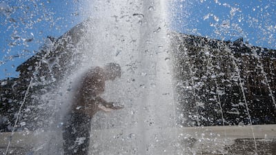 A man cools off in the city centre of Frankfurt, Germany, as temperatures reached up to 40°C
