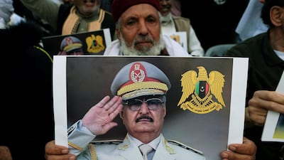 A Libyan man carries a picture of Gen Khalifa Haftar during a demonstration to support Libyan National Army offensive against Tripoli. Reuters, file