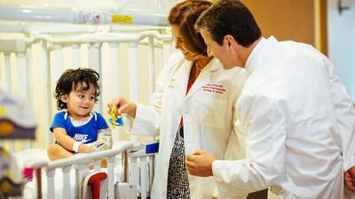 Dr Anthony Sandler, from the Sheikh Zayed Institute for Paediatric Surgical Innovation, and Dr Clarivet Torres, a paediatric gastroenterologist, with a young patient under their care in Washington DC. Courtesy Sheikh Zayed Institute for Paediatric Surgical Innovation