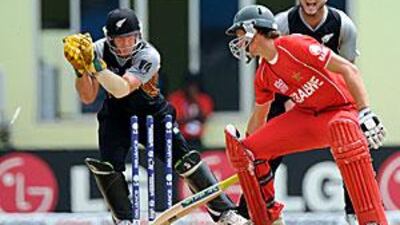 New Zealand's Gareth Hopkins, left, stumps Craig Ervine of Zimbabwe for one at Providence Stadium. The Kiwis won by nine wickets on D/L method in the rain-curtailed match.