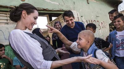UNHCR Special Envoy Angelina Jolie meets Falak, 8, during a visit to West Mosul, Iraq. Falak has a gene disorder and PTSD and spoke to Jolie about seeing a man killed in front of her during the ISIS occupation of the city. Andrew McConnell / UNHCR via Getty