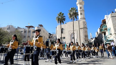 Members of a Palestinian band march through the square. EPA