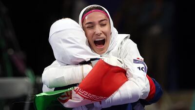 Iran's Mobina Nematzadeh celebrates beating Saudi Arabia's Dunya Ali M Abutaleb in the taekwondo women's -49kg bronze medal bout of the Paris 2024 Olympic Games at the Grand Palais in Paris on August 7, 2024. (Photo by David GRAY / AFP)