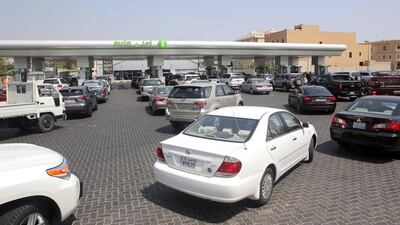 Kuwaitis queue up to fill their cars with fuel at a petrol station in Kuwait City on August 31 – on the eve of increased petrol prices. Yasser Al Zayyat / AFP