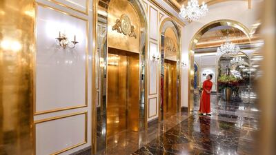 A staff member stands near the lifts in the lobby of Hanoi Golden Lake hotel. AFP