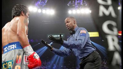 Referee Kenny Bayless gestures to Manny Pacquiao after Pacquiao was knocked down by Juan Manuel Marquez in the third round of their welterweight fight. Steve Marcus / Reuters