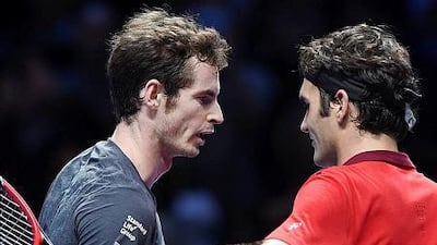 Britain's Andy Murray, left, following his 6-0, 6-1 defeat by Switzerland's Roger Federer during a round robin match at the ATP World Tour Finals mens tennis tournament at the O2 Arena in London, Britain, 13 November 2014. EPA/ANDY RAIN