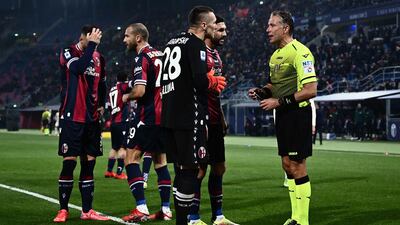 Bologna's Italian midfielder Roberto Soriano receives a red card from referee Paolo Valeri. AFP