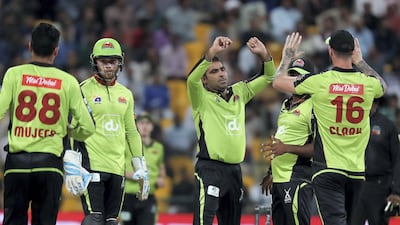 Sultan Ahmed, centre, of Qalandars celebrates after taking the wicket of Shafiqullah during the Abu Dhabi T10 match against Karnataka Tuskers in 2019. Pawan Singh / The National