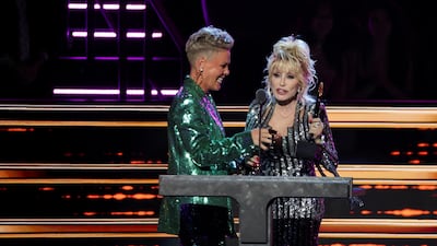 Dolly Parton speaks on stage accompanied by Pink at the 37th annual Rock & Roll Hall of Fame Induction Ceremony in Los Angeles, California. Reuters