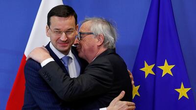Poland's prime minister Mateusz Morawiecki, left, is welcomed by European Commission president Jean-Claude Juncker in Brussels. REUTERS/Yves Herman