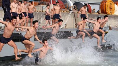 Members of the South Korean Navy Ship Salvage Unit, special forces in charge of rescue missions during maritime accidents, jump into the sea in a winter exercise at Changwon. EPA
