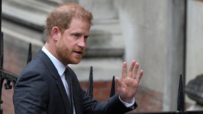 Prince Harry waves to the media as he arrives at the Royal Courts Of Justice in London. AP