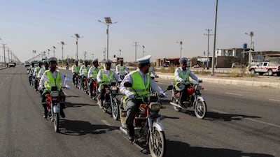 Traffic police escort Taliban forces as they rally to celebrate the withdrawal of US forces in Kandahar, Afghanistan. EPA