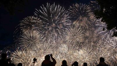 People watch a laser and fireworks show over the Neva River and the Peter and Paul Fortress in St. Petersburg. The show marks the annual school leavers day. Alexander Demianchuk / Reuters
