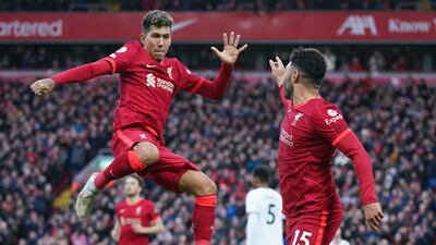 Alex Oxlade-Chamberlain, right, celebrates with Roberto Firmino after scoring Liverpool's second goal. AP