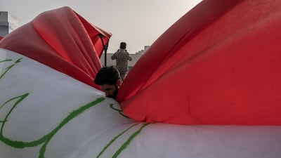 An Iraqi man kisses the Iraqi flag at Tahrir Square during a protest against the US and Israel in Baghdad this month. Getty