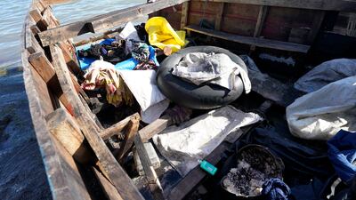 A container with beans and rice, clothes and an inner tube in a recently arrived migrant boat. AP
