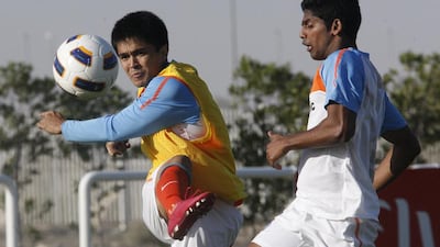 Bangalore striker Sunil Chhetri, left, kicks the ball past Mohun Bagan's Raju Gaikwad, right, during an India national team training session in Dubai. Mike Young / The National