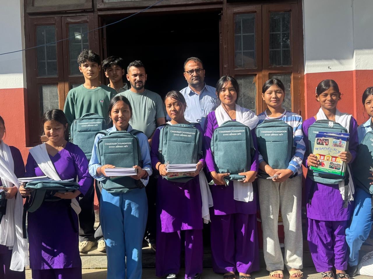 Principal Rajendra Dawadi (far right behind) with pupils from the Tribhuvan Trishuli secondary school who were provided with books, bags and tents to resume school. Photo: Rajendra Dawadi