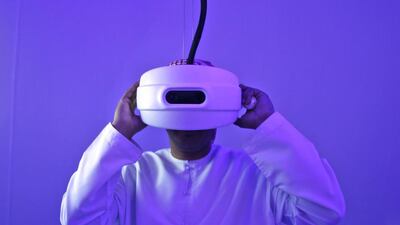 An Emirati man watches through a special viewfinder at the Museum of the future during the opening day of the World Government Summit in Dubai. Kamran Jebreili / AP Photo