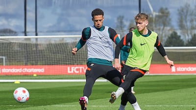 Liverpool's Harvey Elliott passes the ball under pressure from Rhys Williams. Getty