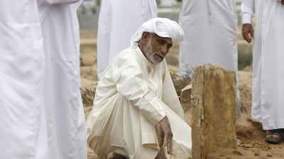 Ali Abdullah Al Qaidi, the uncle of Emirati police officer Tariq Al Shehi who was killed by an improvised bomb in Bahrain while being deployed as part of a joint Arabian Gulf force, sits next to his nephew’s grave. Antonie Robertson / The National