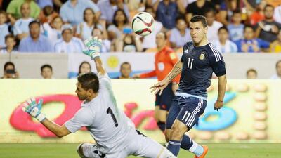 Sergio Aguero lifts the ball over Bolivia goalkeeper Dainel Vaca to score. Scott Halleran / Getty Images