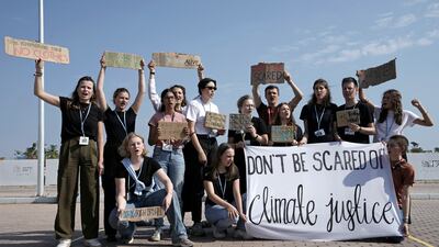Climate activists demonstrate in the designated protest zone. AP