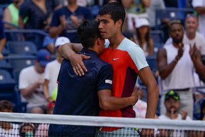 Carlos Alcaraz embraces Sebastian Baez at the net after the Argentine was forced to retire from their US Open first round match. AP
