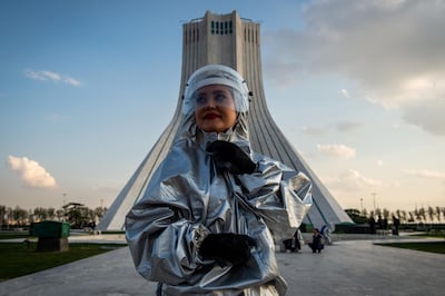 A volunteer wears protective personal equipment during disinfecting operations in Azadi Square in Tehran, Iran, on March 27, 2020. Bloomberg