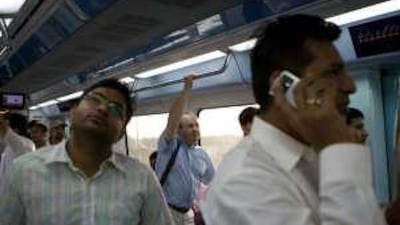 Commuters on the Metro head towards Nakheel Harbour and Tower station during rush hour in Dubai yesterday.