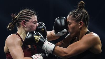 Germany's Verena Kaiser, left, and Estelle Yoka-Mossely of France during their IBO lightweight title fight at the H Arena in Nantes, western France, on Friday, March 5. Yoka Mossley won the bout on points. AFP
