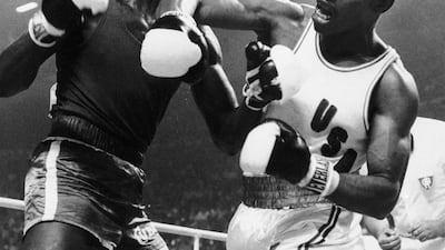 Leon Spinks lets fly with his right at the face of Cuba's Sixto Soria during light heavyweight boxing action at the Olympics in Montreal, July 31, 1976. AP