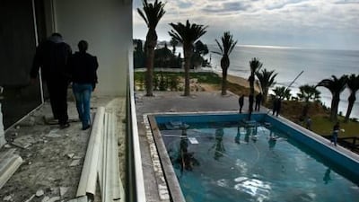 People walk on the balcony overlooking the pool as they visit the burnt and looted house that belonged to the nephew of ousted Tunisian President Zine El Abidine Ben Ali in Hammamet, some 60 kms south-east of Tunis.