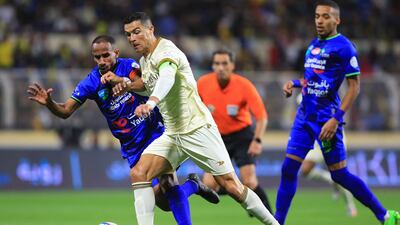 Nassr's Portuguese forward Cristiano Ronaldo fights for the ball with past Fateh's Saudi midfielder Mohammed Al Fuhaid. AFP