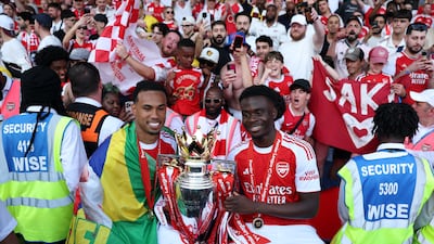 Gabriel and Bukayo Saka of Arsenal celebrate with the Premier League Trophy after the end of the season at Selhurst Park. Getty Images