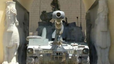 An American soldier stands on a Bradley tank stationed at the main entrance of the National Museum in Baghdad in June 2003.