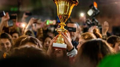 Members of the Amuda women's team carry the winner's cup as they are greeted by locals in the northeastern Syrian town of Amuda in Hasakeh province upon their return from a football tournament in Damascus. AFP
