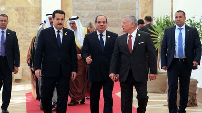 Mr Al Sudani, Mr El Sisi and King Abdullah on the red carpet. EPA