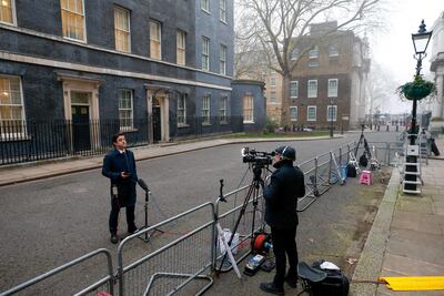 A television journalist stands outside 10 Downing Street in London ahead of Mr Sunak's budget on Wednesday. Bloomberg