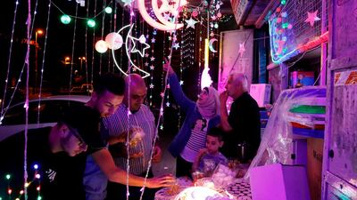 Palestinians check a shop selling Ramadan lights in the old city of Jerusalem. AFP